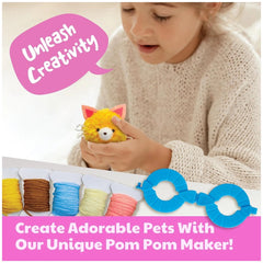 Young girl in a white sweater holds a blue pom pom maker, colorful yarn, and scissors while creating a plush toy.