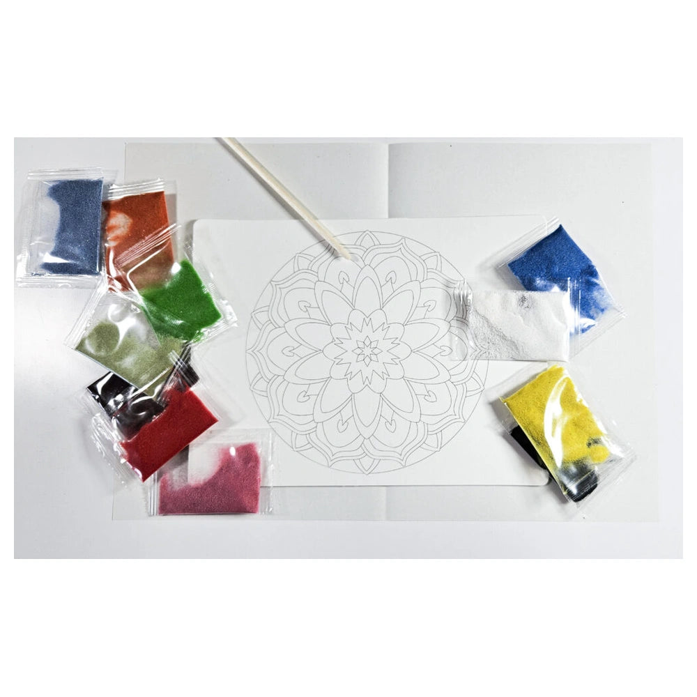 Sand art mandala kit with vibrant color packets and a paintbrush on a white surface, designed for eco-friendly crafting.