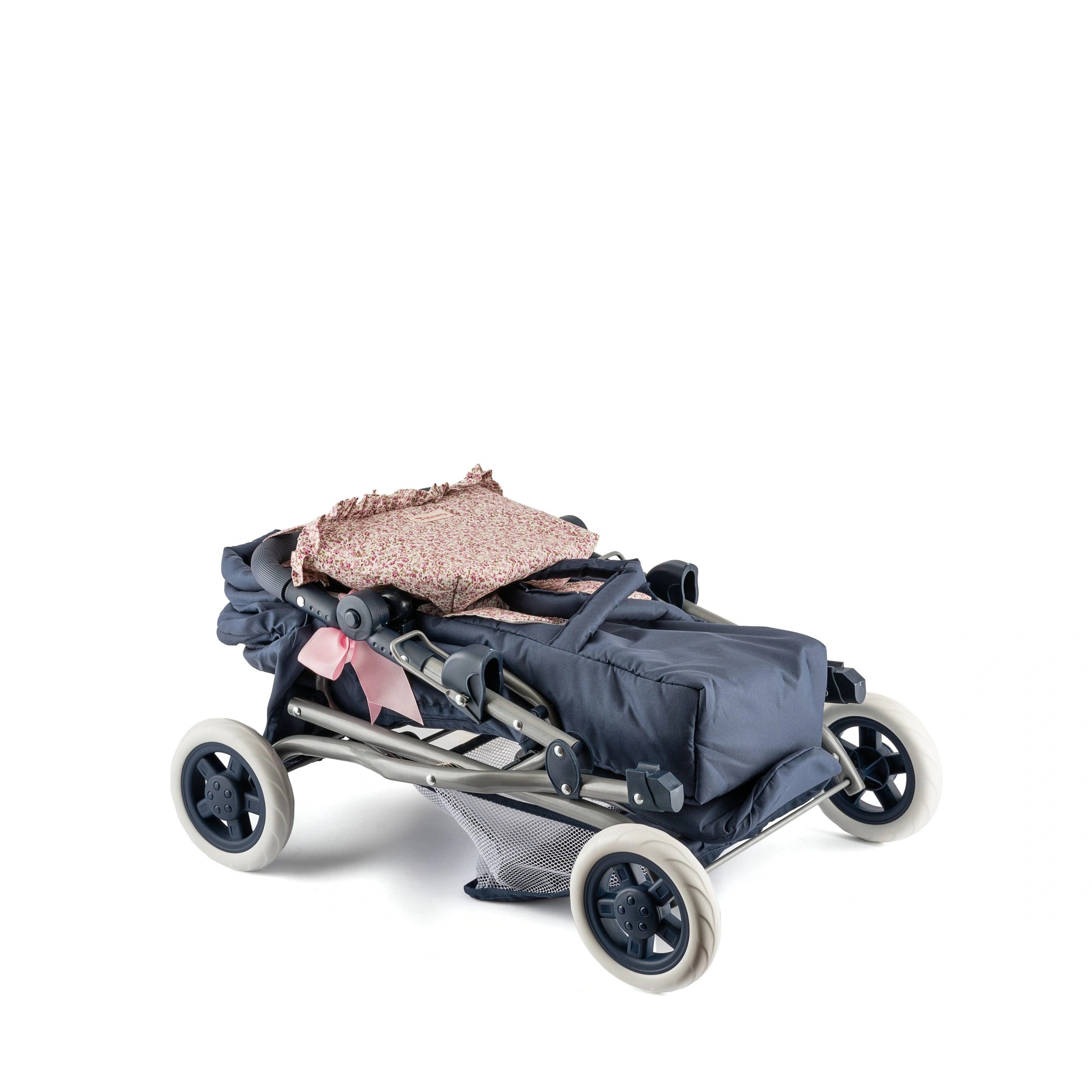 Folded navy stroller with cream wheels and floral fabric on top, designed for 36 to 46 cm dolls.