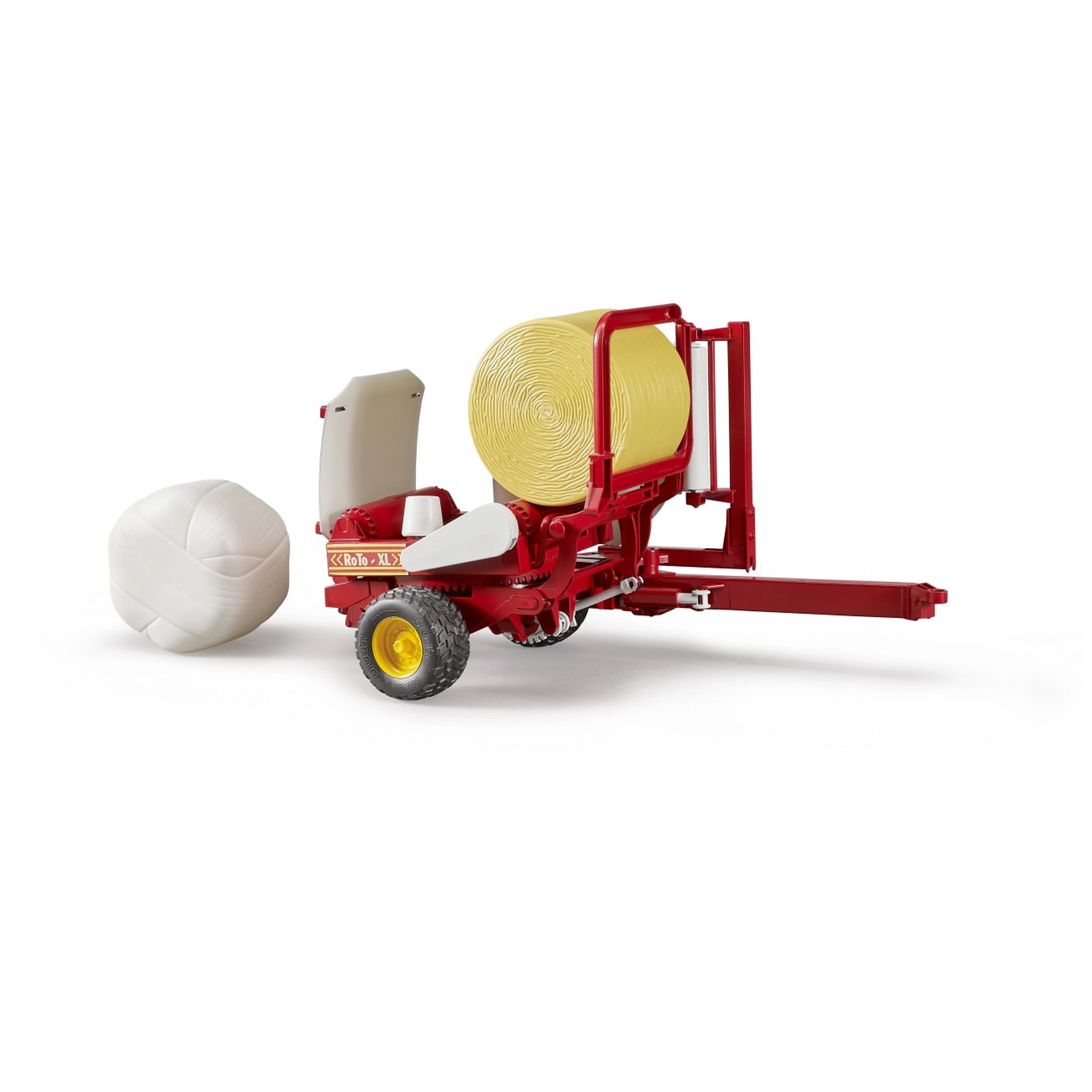 Red and yellow Bruder bale wrapper toy with round bales, simulating farm equipment.
