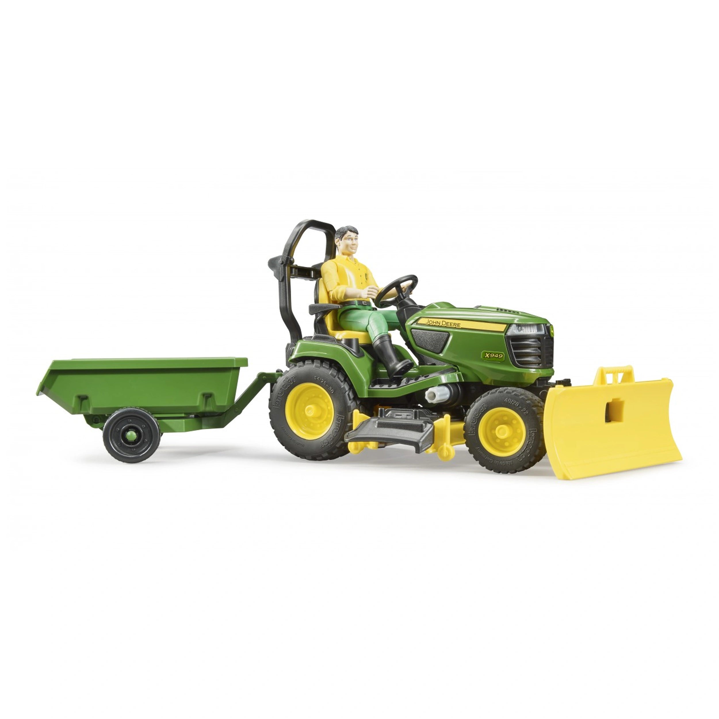 John Deere lawn tractor toy with a figure, green trailer, and yellow snow plough attachment, side view.