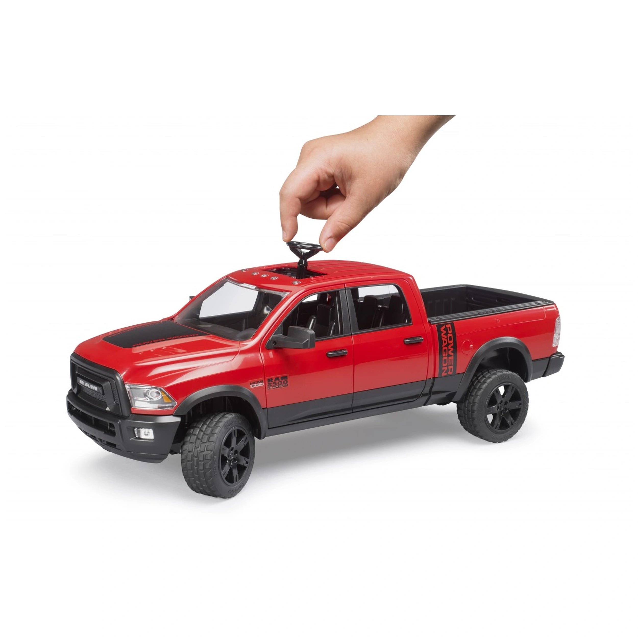 Red Bruder RAM 2500 Power Wagon toy with hand turning steering knob, featuring realistic details and robust design.