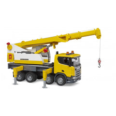 Yellow Scania 560R Liebherr crane truck toy with extended telescopic arm and red hook, on stable supports.