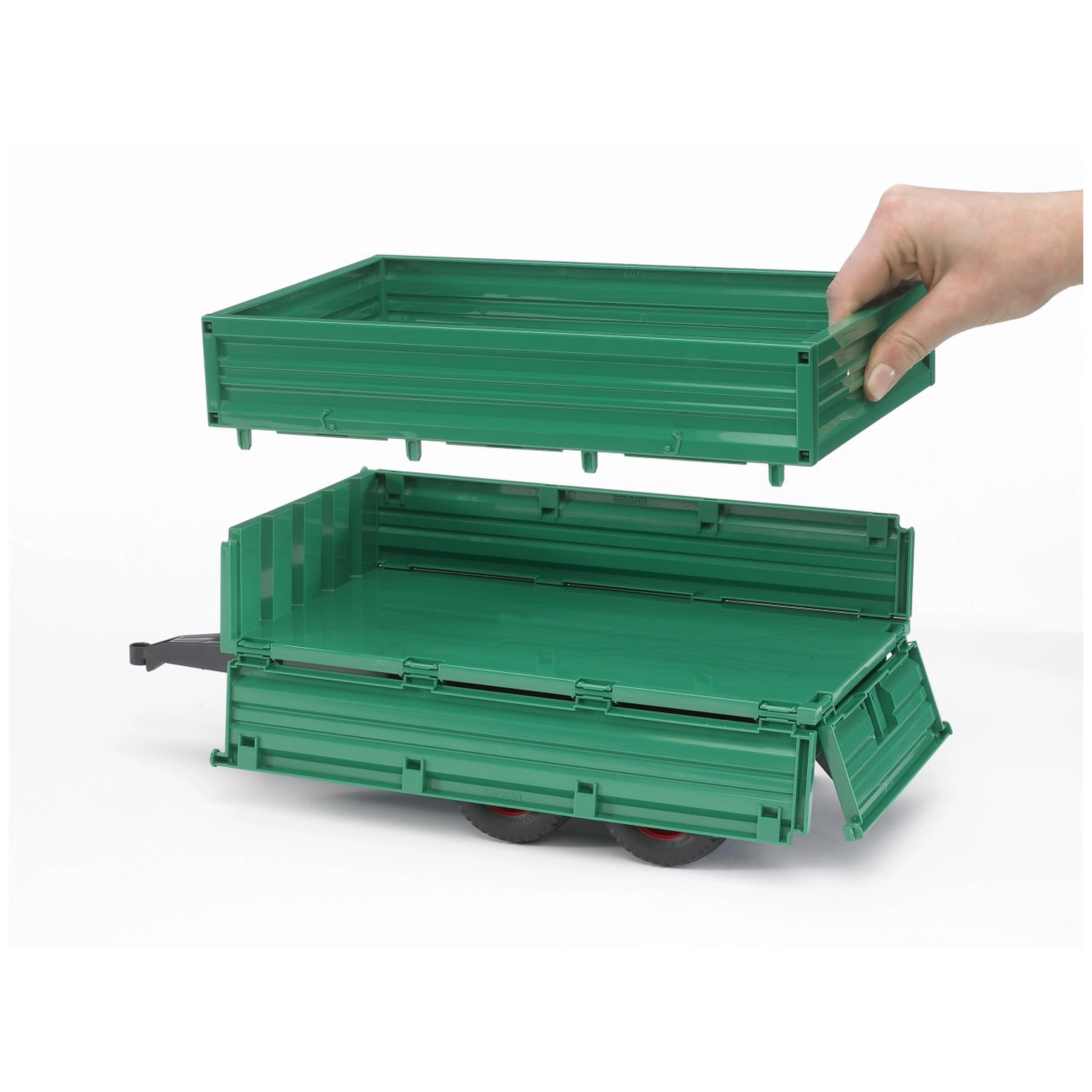 Green Bruder tandemaxle trailer with removable top section being lifted by a hand, showcasing three side gates.