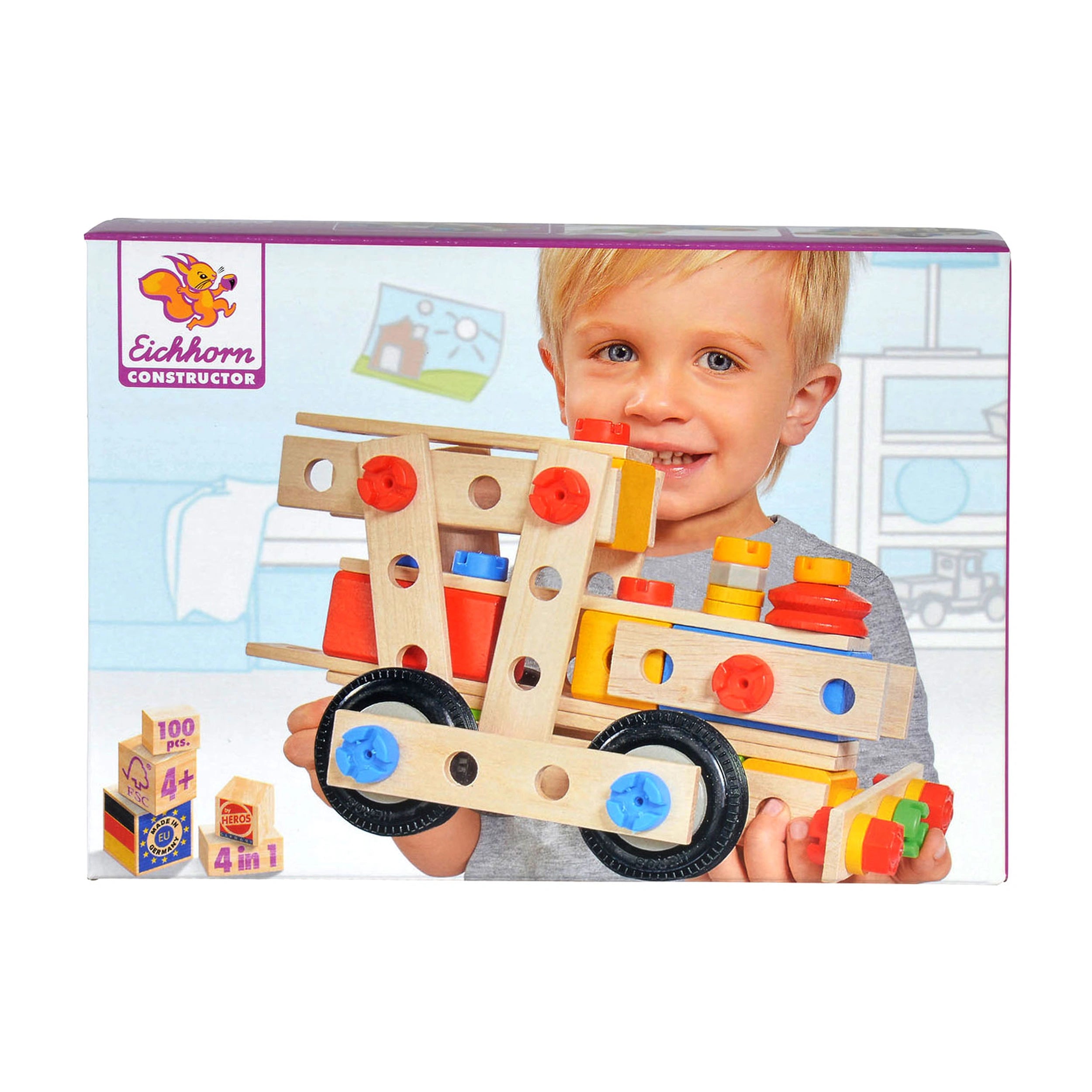 Eichhorn Constructor 4 in 1 construction set packaging held by a young child with blonde hair and a gray shirt, smiling.