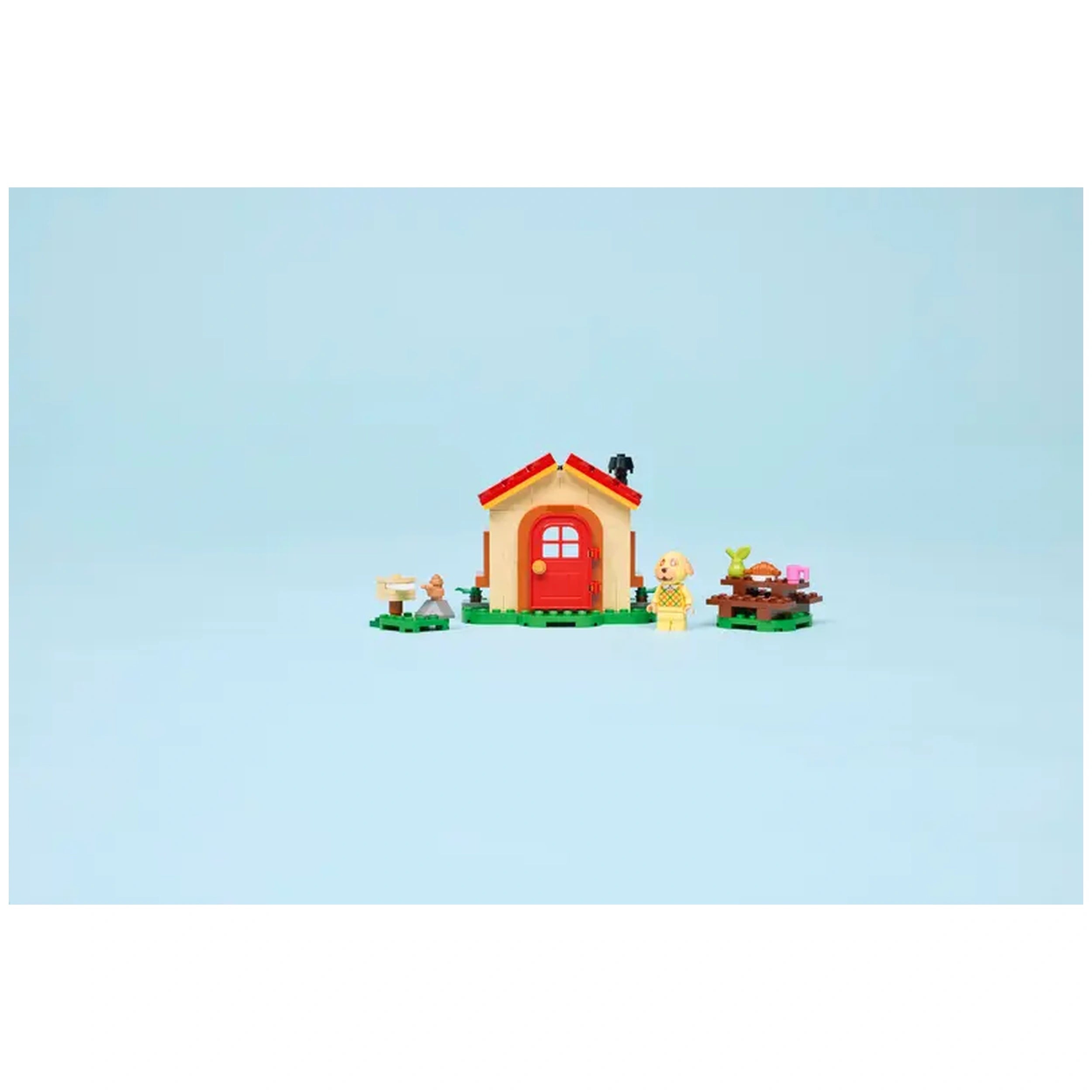 LEGO Goldie's Cozy House set featuring a colorful, charming house with a red door, a Goldie minifigure, and outdoor picnic setup.
