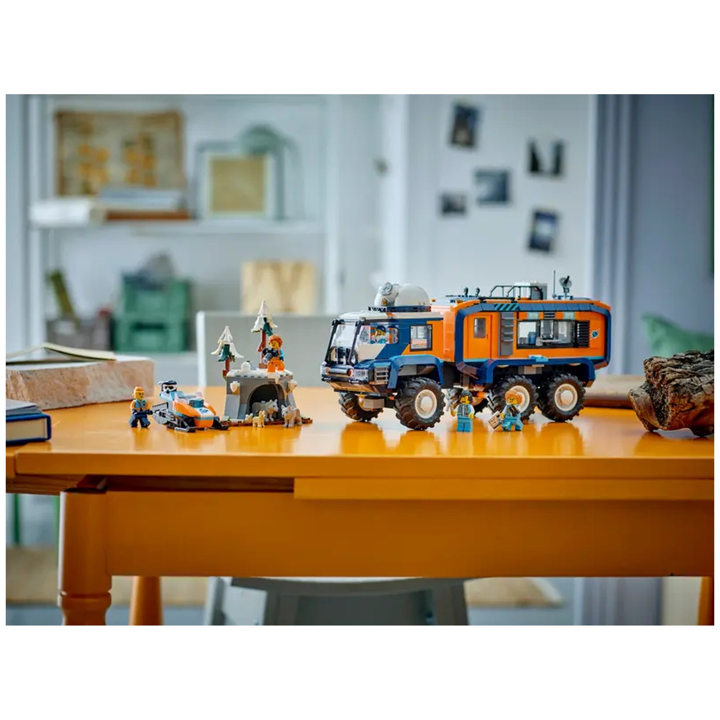 LEGO Arctic Explorer Science Lab Truck on an orange table, featuring mini-figures, a snowmobile, and icy terrain elements.