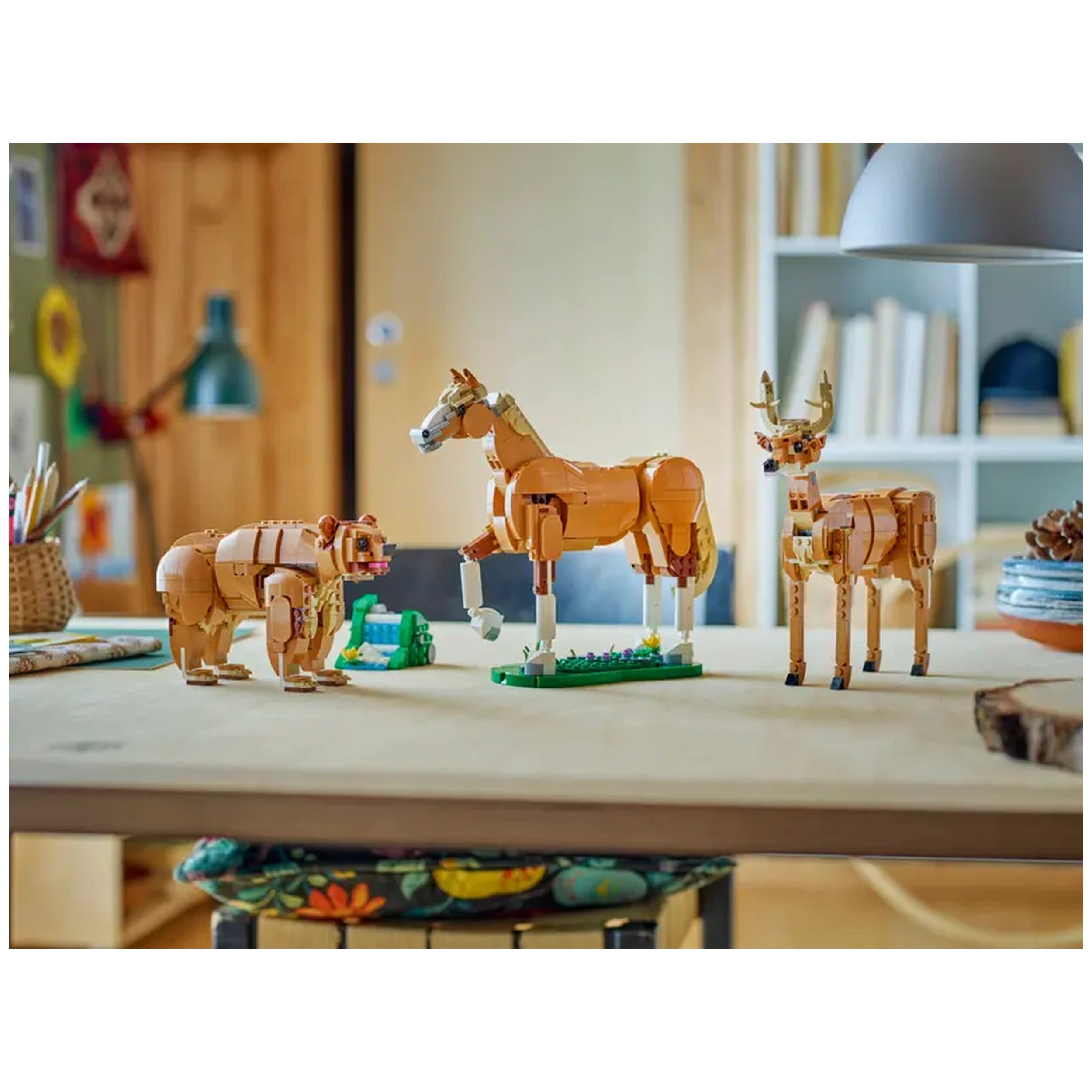 Highly posable LEGO Creator horse stands between a bear and a deer on a wooden table, showcasing vibrant colors and a grassy base.