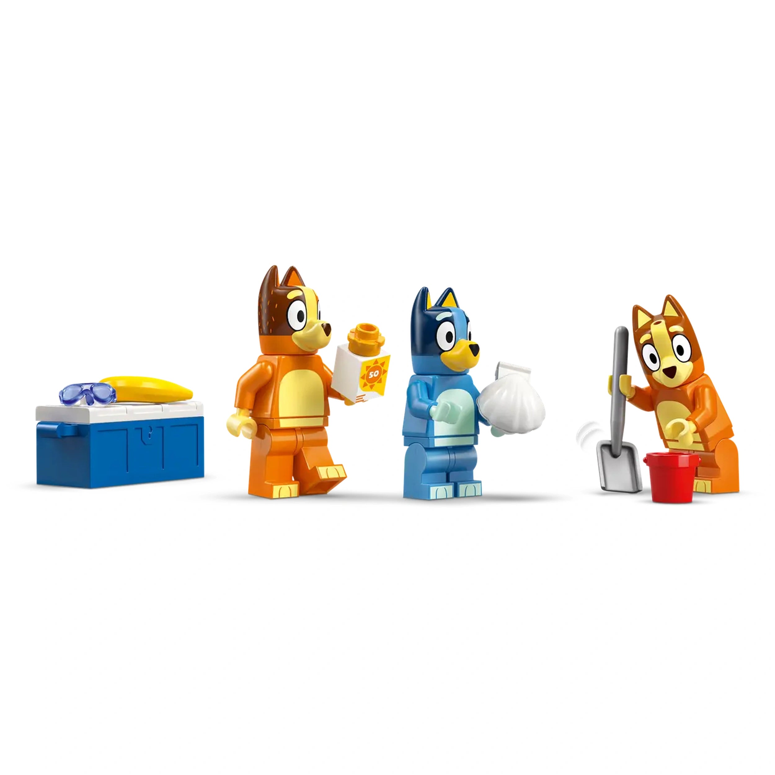Four LEGO figures from the Bluey series stand in a row against a white background. The first figure, in orange, holds a snack and has a surfboard nearby. The second figure, in blue, holds a white bag. The third figure, in orange again, uses a shovel near a red bucket. These playful characters engage in fun beach-themed activities, perfect for imaginative play.