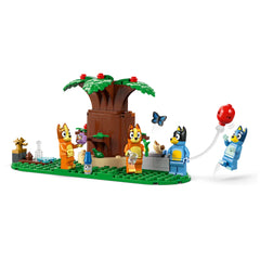 LEGO Bluey's Family House playset featuring interactive characters Bluey, Bingo, Chilli, and Bandit among vibrant greenery and accessories.