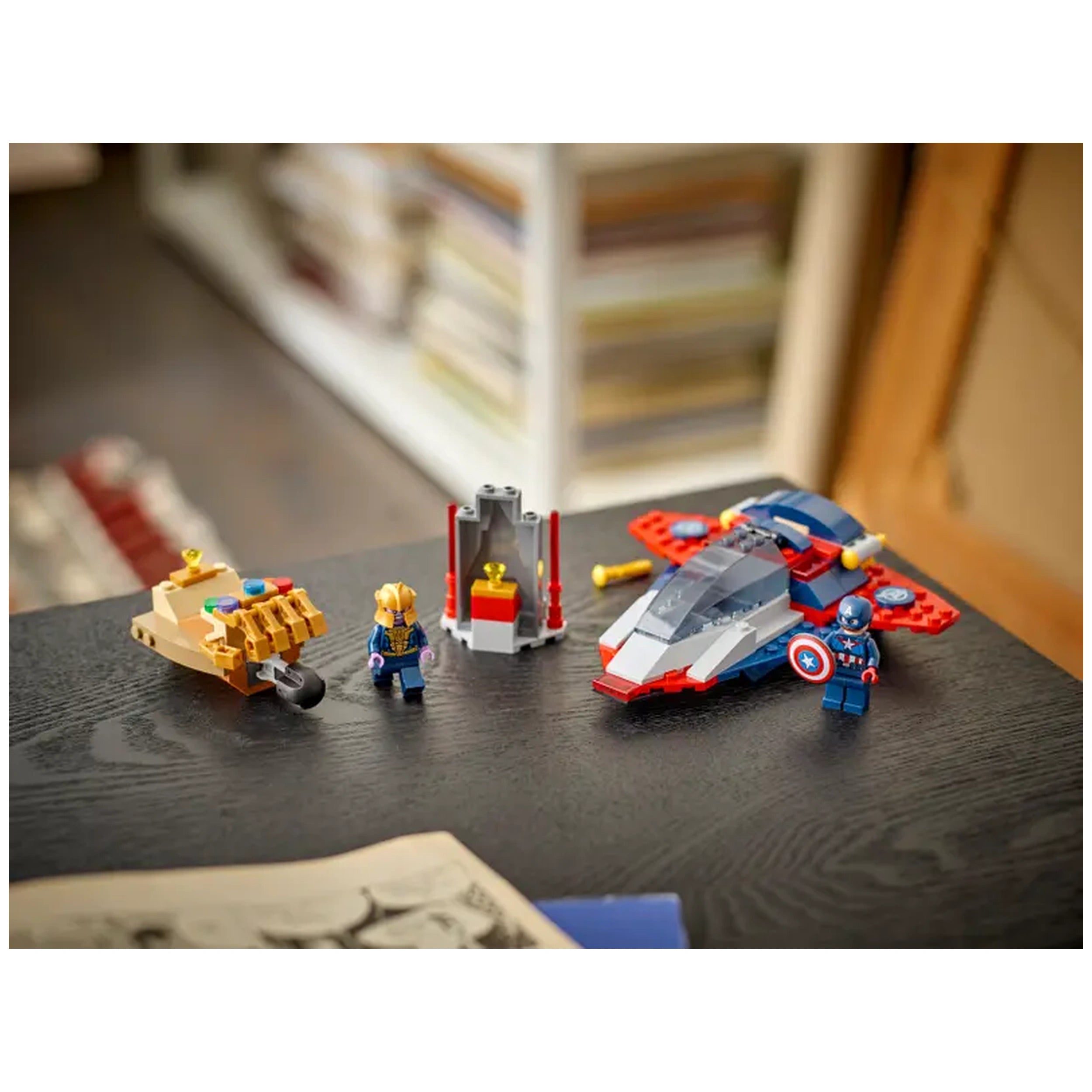 LEGO Captain America and Thanos playset on a dark wooden table, featuring detailed minifigures, Thanos's Infinity Gauntlet, and Captain America's Quinjet.