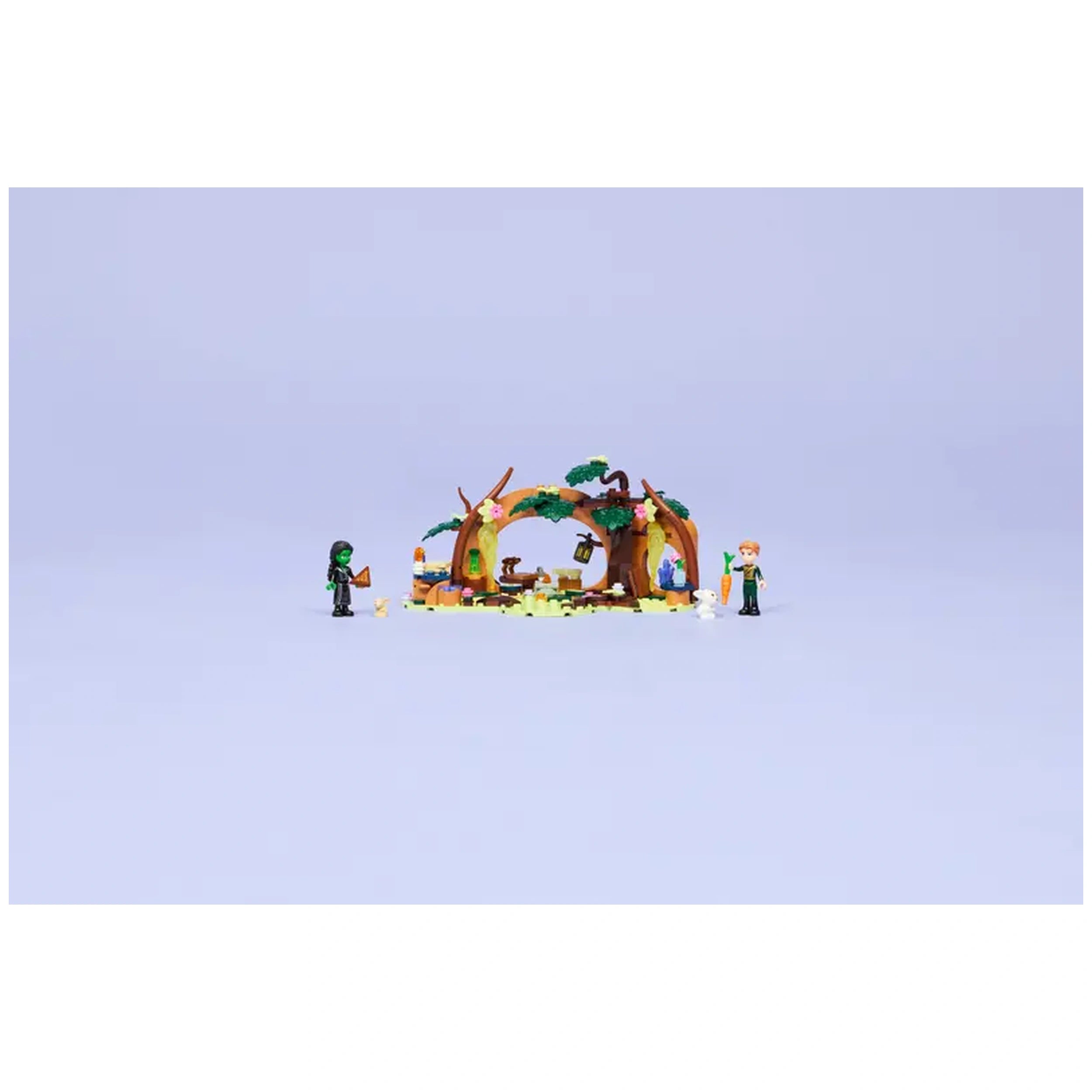 LEGO Elphaba's Retreat set featuring Elphaba and Fiyero figures in a whimsical forest setting with trees, flowers, and a cozy fireplace.