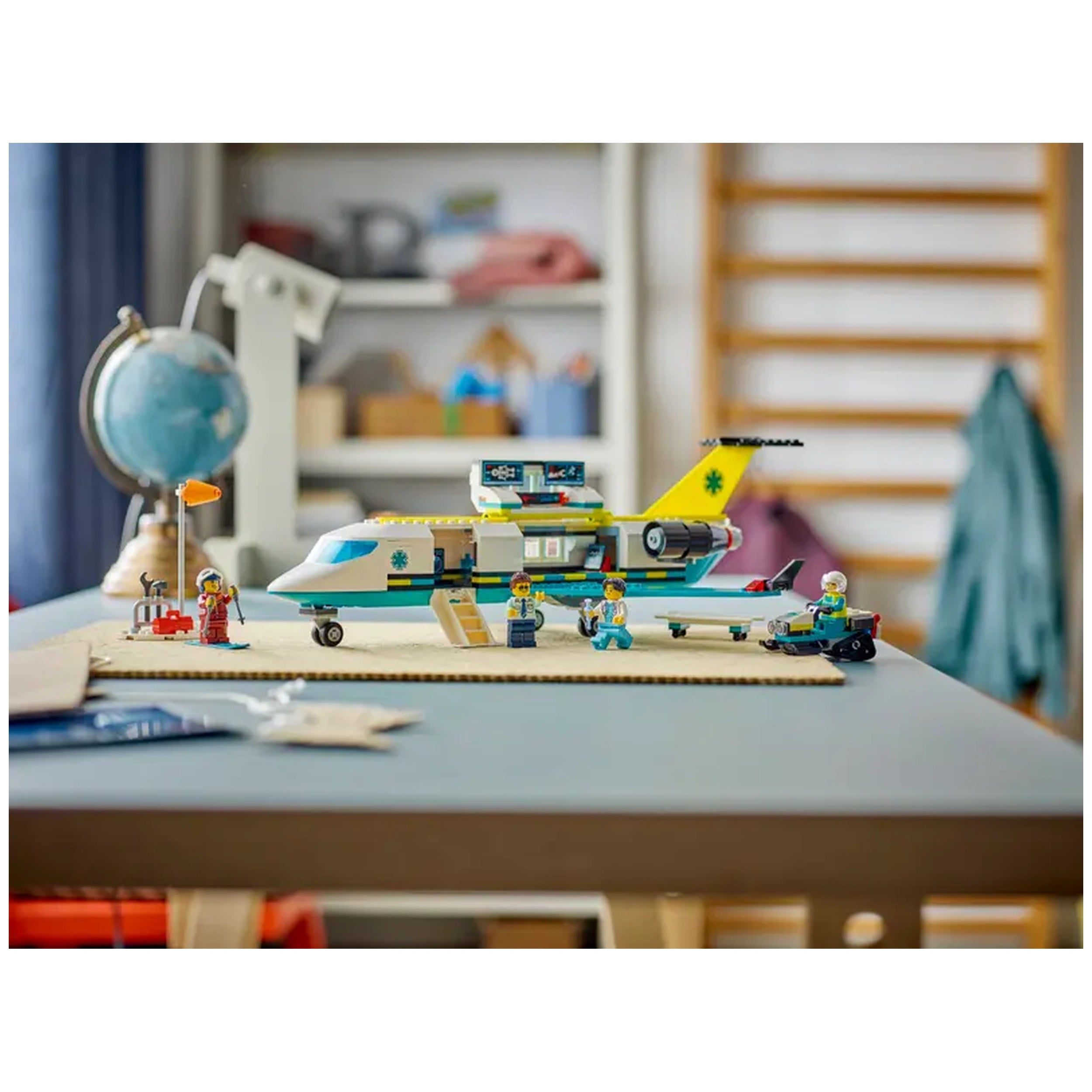 LEGO Emergency Air Ambulance Plane set featuring a colorful twin-engine airplane, minifigures of a pilot, doctor, and paramedic, alongside a snow scooter.