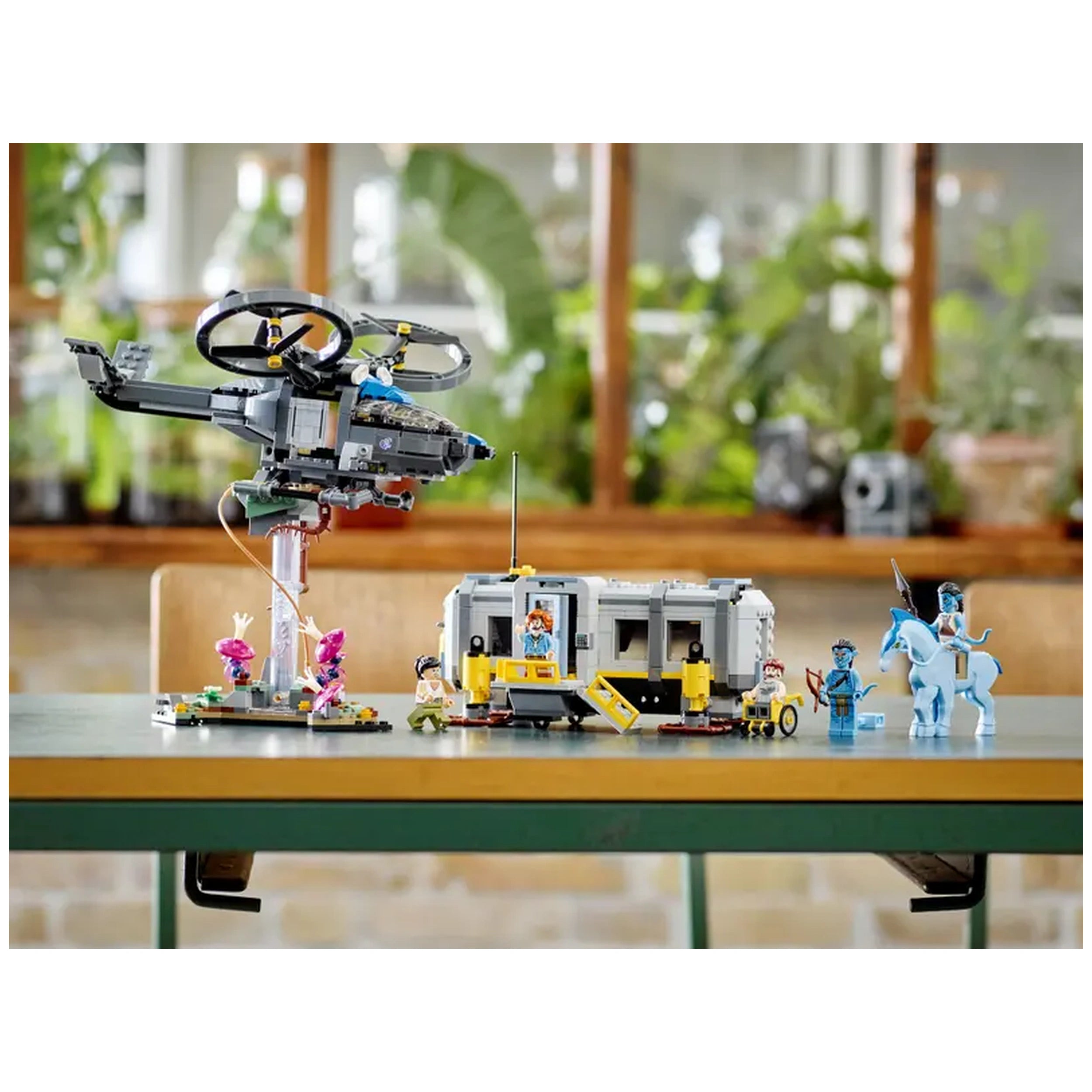 LEGO® Avatar Floating Mountains set features a futuristic SA-2 Samson helicopter, a detailed Site 26 container, and minifigures of Jake Sully in Na’vi and human forms, alongside other characters and a Direhorse figure, all set against a lively indoor backdrop.