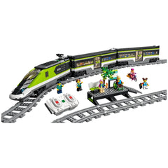 LEGO City Express Passenger Train set with a sleek green and gray locomotive, two minifigures, remote controls, and a waiting area with a tree.