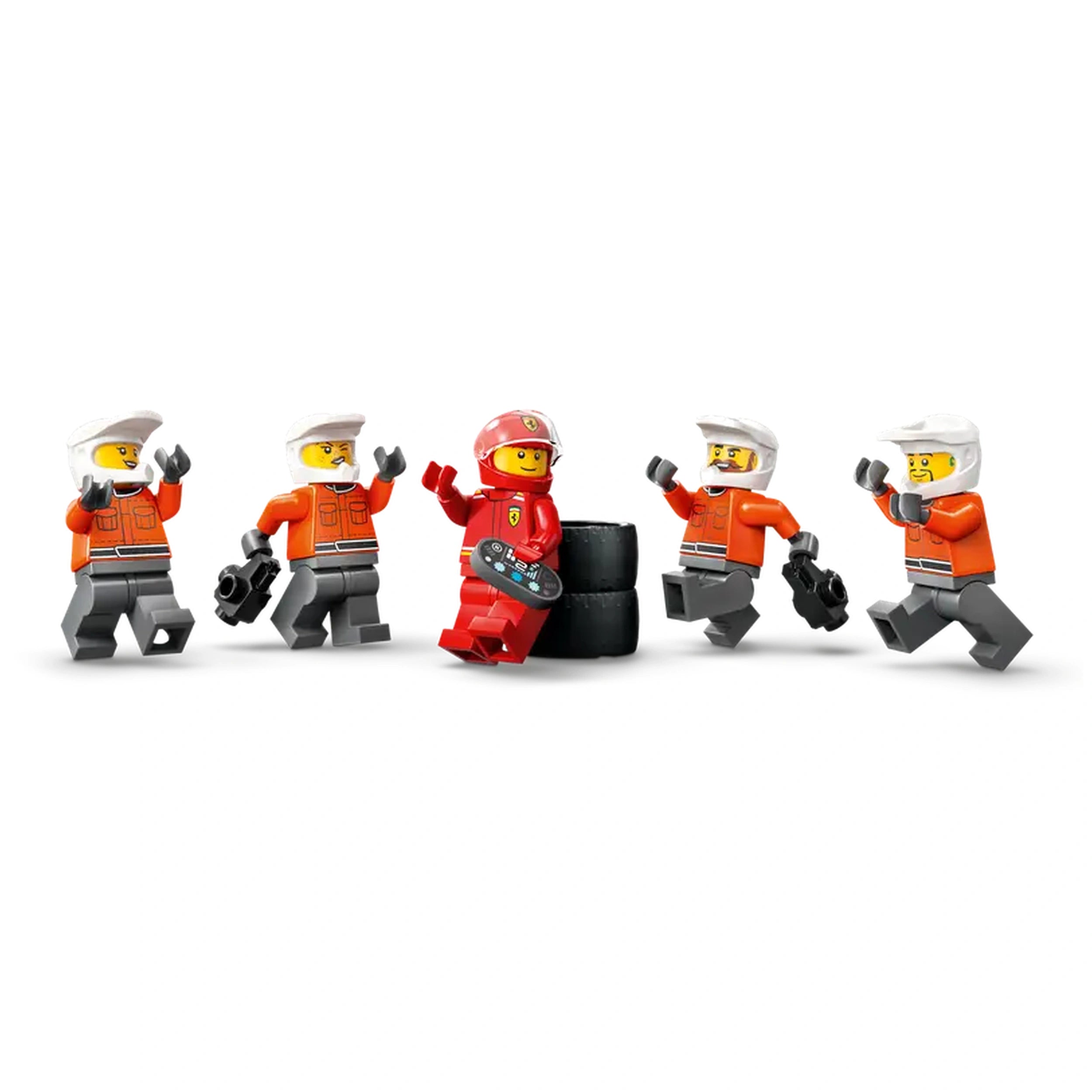 Five LEGO minifigures in racing outfits surround a black tire stack, with one wearing a red Ferrari uniform, while the crew joyfully celebrates a pit stop.