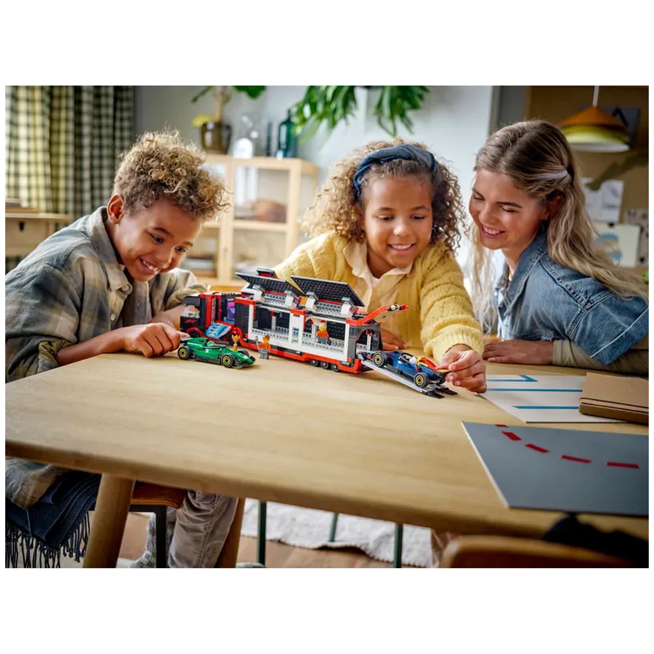 Three children and an adult gather around a wooden table, engaging with the LEGO® City F1® Truck set. The truck features a detachable trailer, and the children are playfully positioning the colorful RB20 and AMR24 F1® cars. Bright, cheerful expressions highlight their excitement as they explore this immersive racing-themed playset. A cozy, well-lit room serves as the backdrop.