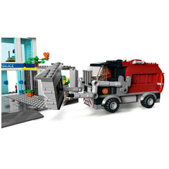 LEGO City Police Station set featuring a red and black truck breaking into a jail, with a crook escaping and a police station in the background.