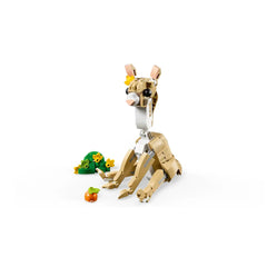 Cute LEGO Creator bunny figure with a flower on its head, sitting beside a patch of grass and a carrot. Bright and engaging design.