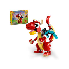 Bright red LEGO Creator dragon with big expressive eyes, colorful wings, and friendly features, next to its 3-in-1 box.
