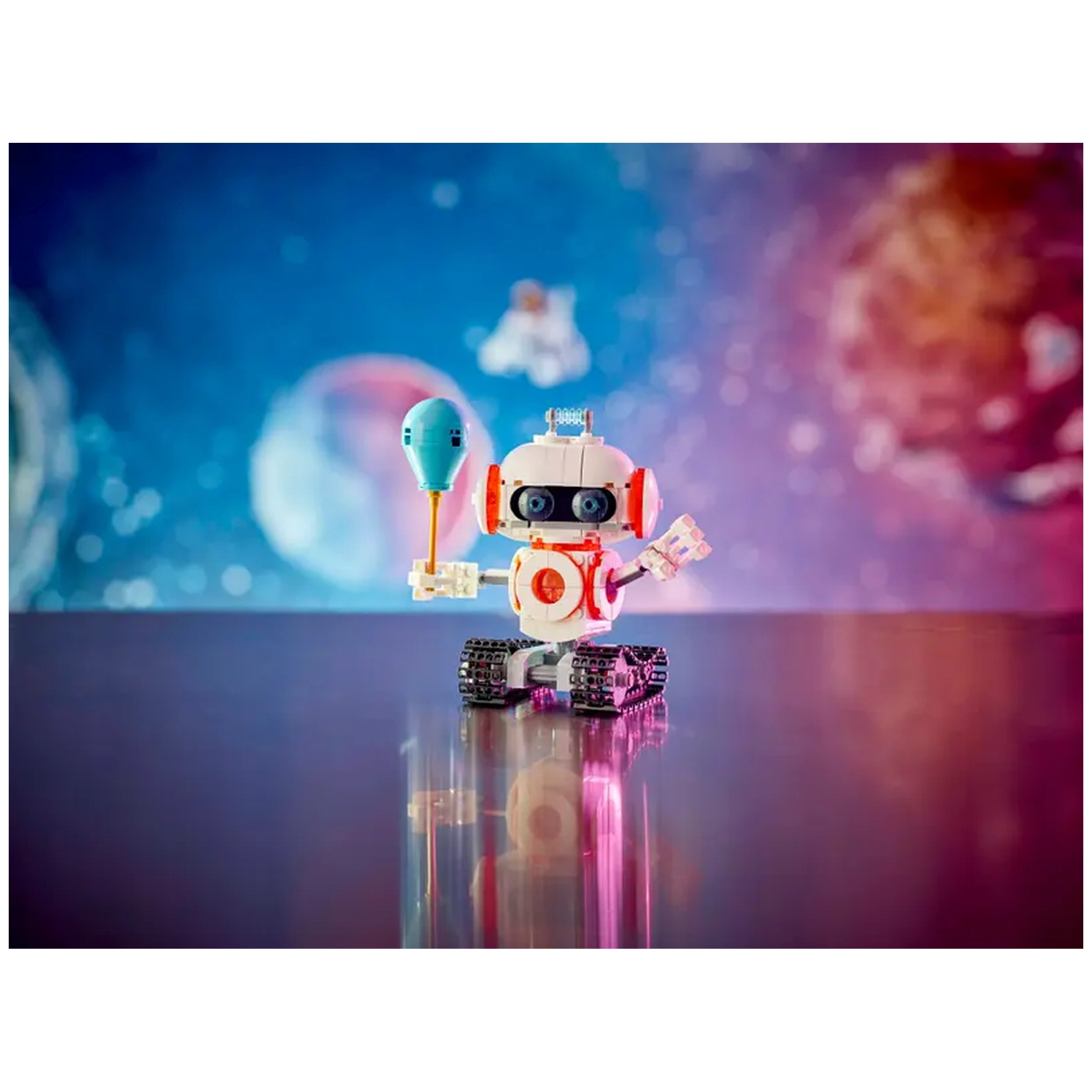 A colorful LEGO® Creator 3in1 Space Robot stands on a reflective surface, holding a blue object. The background features a vibrant space scene with planets and stars, enhancing the imaginative feel of intergalactic adventures.