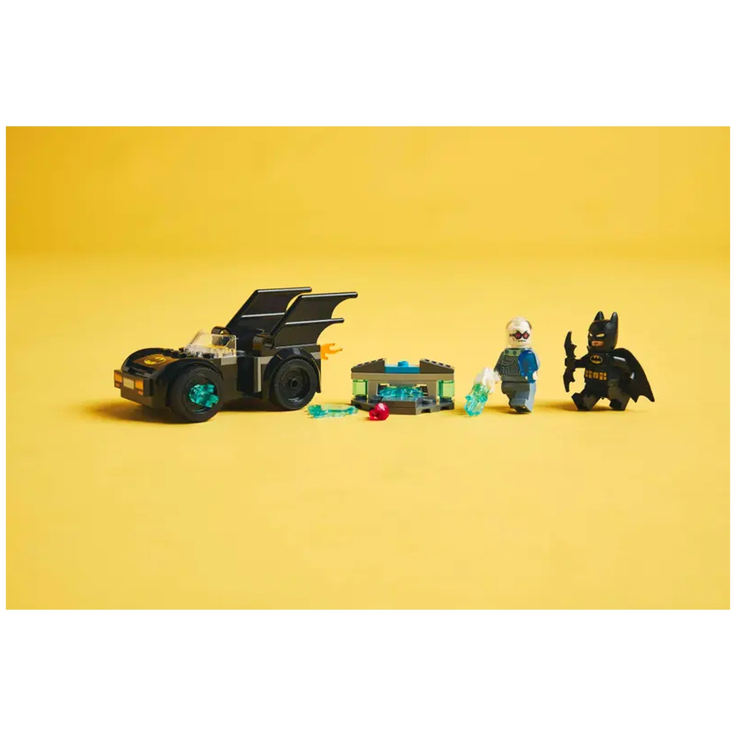 LEGO Batmobile in black with turquoise accents, alongside Batman and Mr. Freeze minifigures, set against a yellow background.