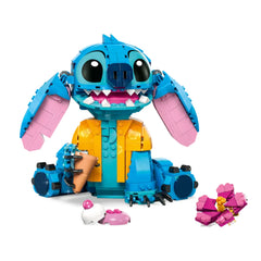 LEGO® construction set features Stitch, a blue alien with movable ears, in a Hawaiian shirt, holding an ice cream cone, surrounded by colorful accessories.