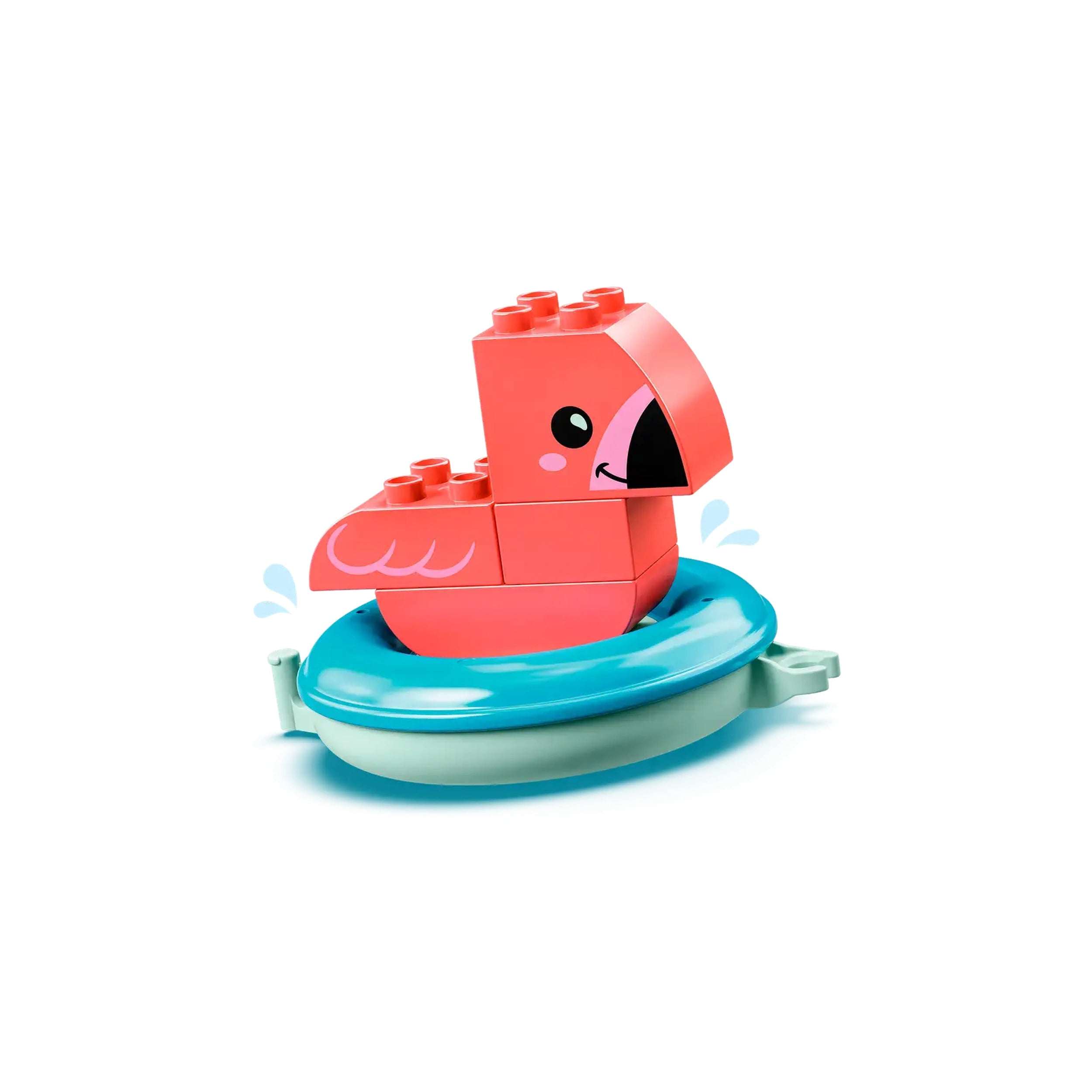 Bright pink LEGO flamingo sits on a blue floating ring, surrounded by playful splashes of water. The cheerful design is perfect for toddler bath fun.