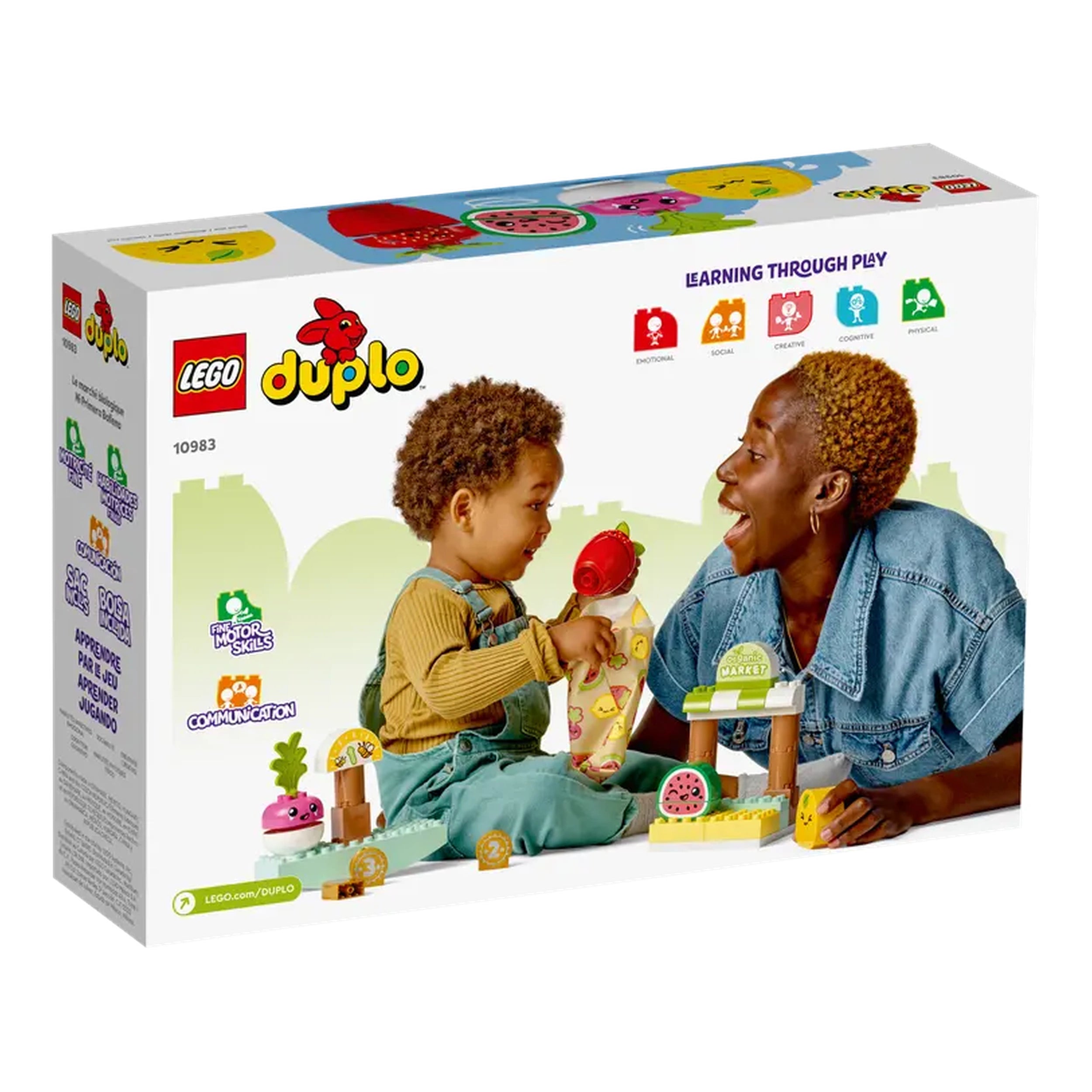 Toddler and adult enjoying a playful moment with LEGO® DUPLO® set, featuring a market stand, colorful fruits, and toy coins.