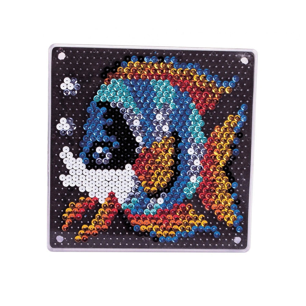 A colorful sequin fish art activity features a glossy rectangular surface adorned with vibrant beads arranged in a fish desig