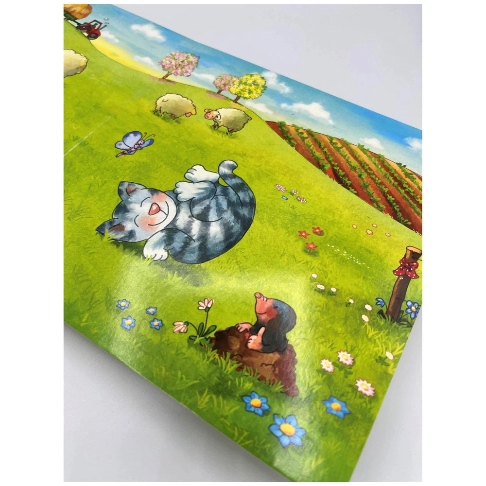 ARENA - Mein kleines Puzzle-Buch features a colorful whimsical illustration of a cartoon cat in a sunny field with sheep and 