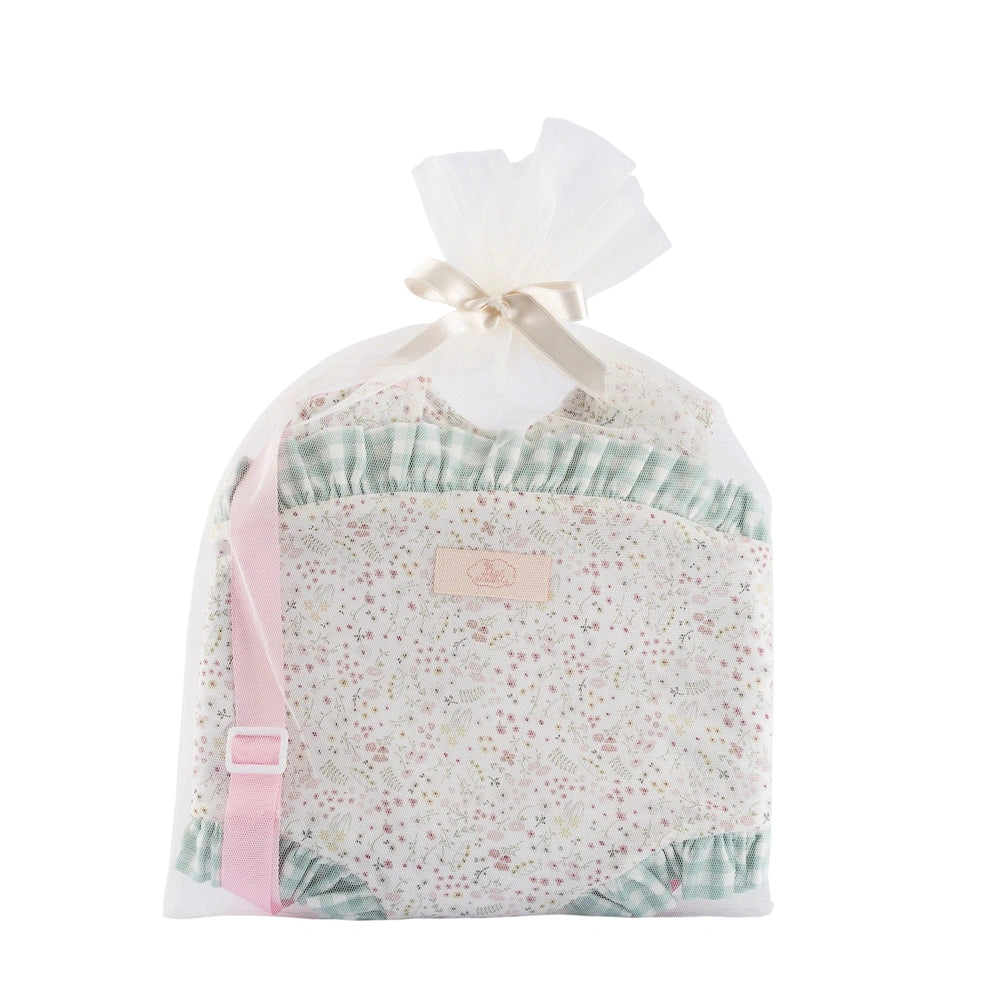 Soft pastel floral baby carrier with pink strap and green ruffles, packaged in a sheer white ribboned bag.