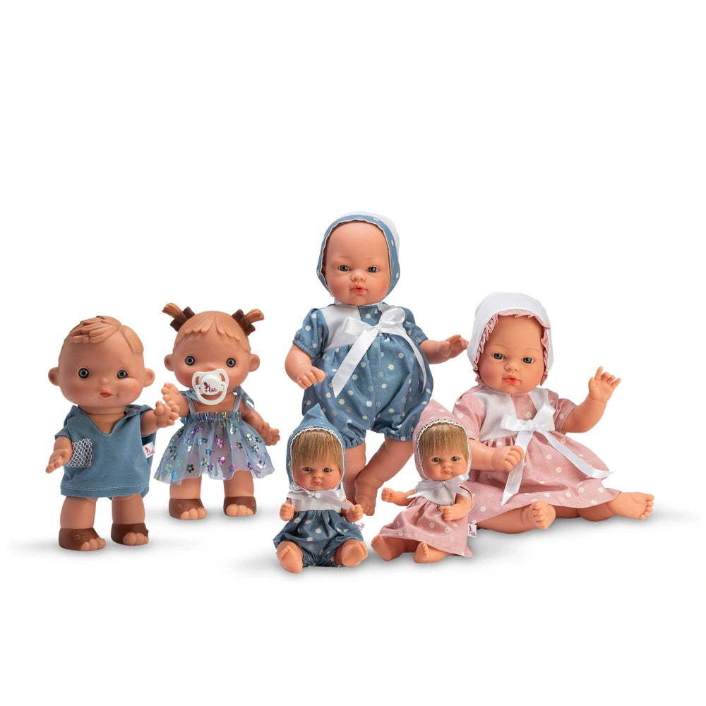 Six dolls from the ASI Dolls Koke Ranita collection, dressed in blue and pink outfits, sitting and standing.