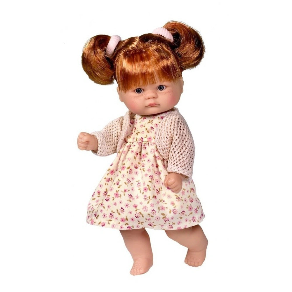 Red-haired doll in floral dress and knit cardigan, standing with expressive blue eyes and clenched fists.