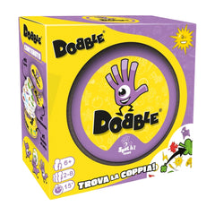 ASMODEE Dobble card game packaging in purple with yellow accents, featuring playful graphics and symbols for the matching game.