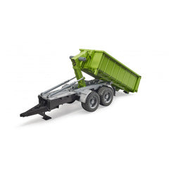 Green Bruder hook lift trailer for tractors, featuring a tilting trough and double doors, on a white background.