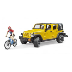 Yellow Jeep Wrangler Rubicon toy with cyclist on mountain bike, showcasing off-road adventure play.