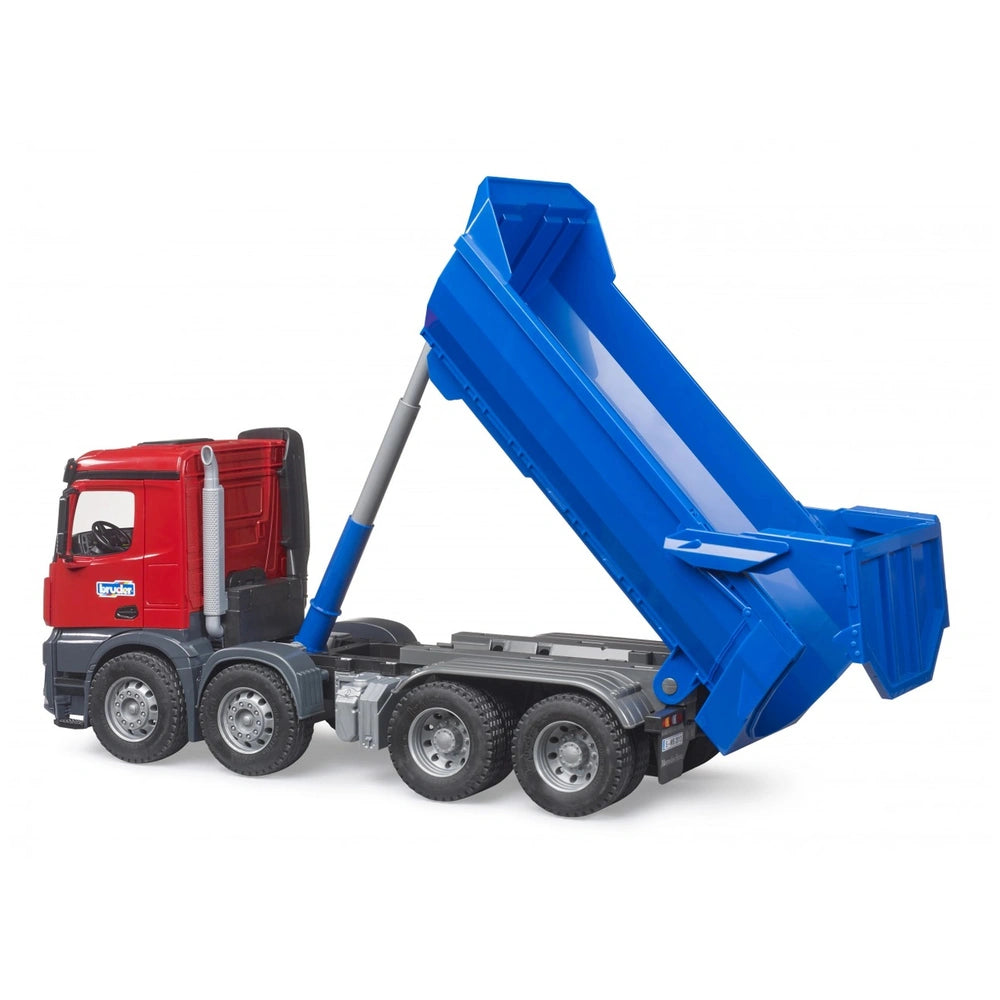 Red and blue Bruder MB Arocs Halfpipe Tipper Truck toy with raised blue bed, showcasing detailed wheels and cabin features.
