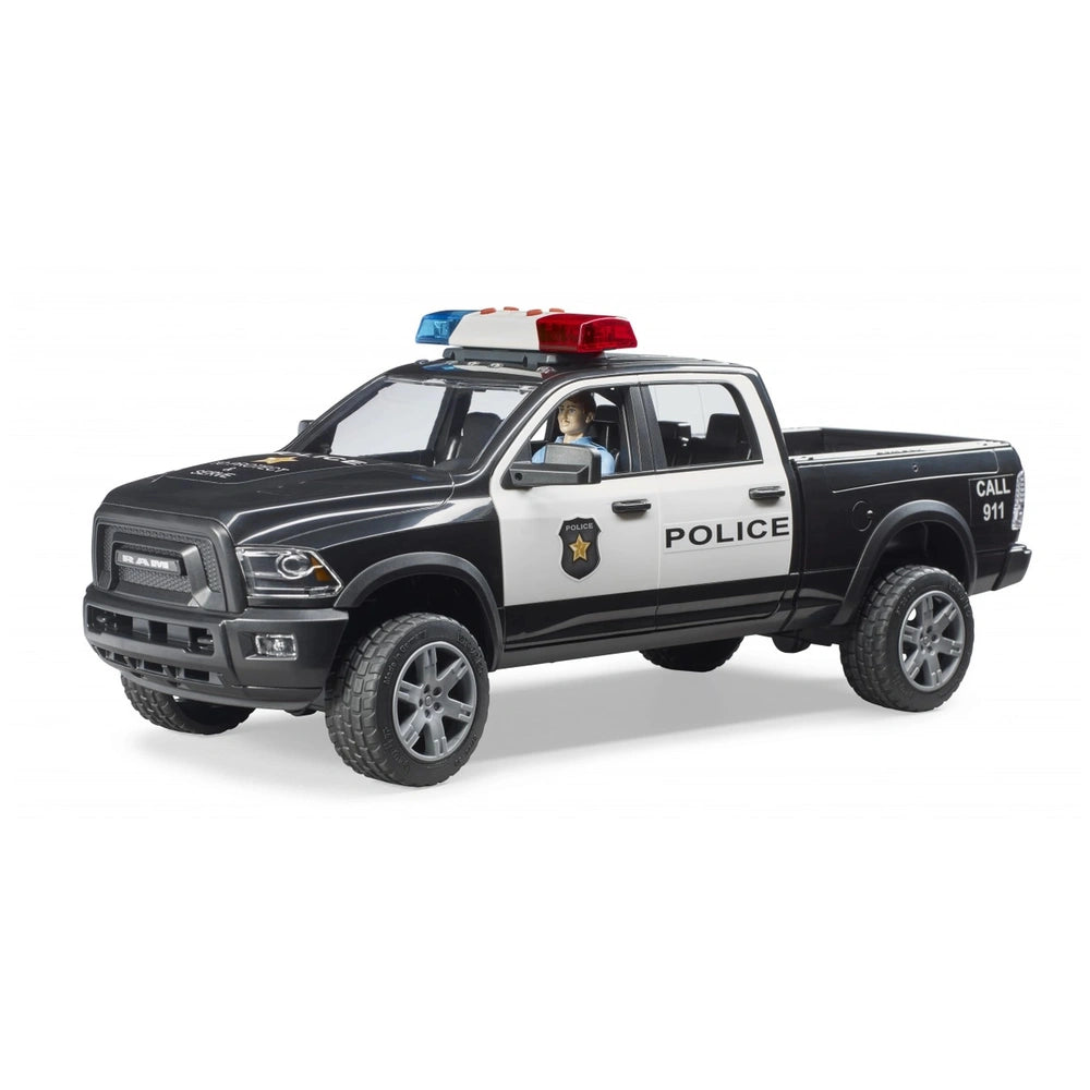 Black and white police pick-up toy truck with police decals, officer figure inside, and roof lights.