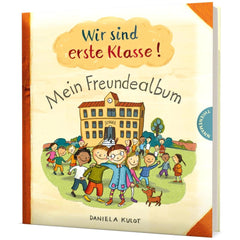CARLSEN educational toy album features a glossy title on a matte beige cover, with children playing near a red-roofed school.