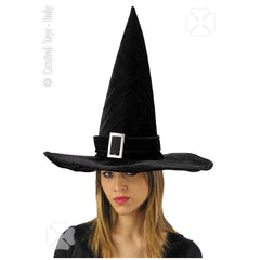 Black velvet witch hat with a shiny fabric and silver buckle, worn by a person for Halloween dress-up fun.