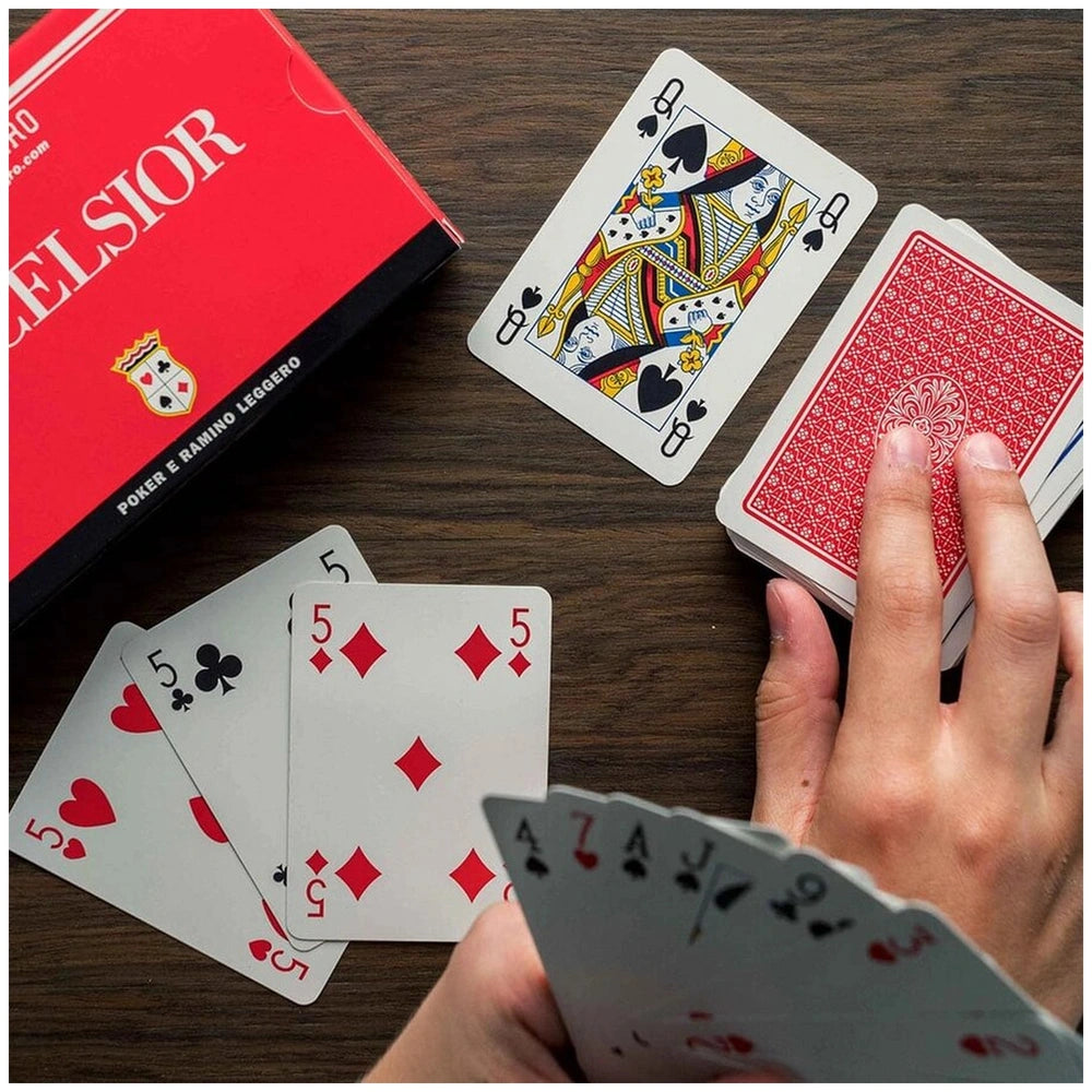 Dal Negro Excelsior Rummy Cards in blue-red deck, featuring glossy playing cards and a textured red box on a wooden surface.
