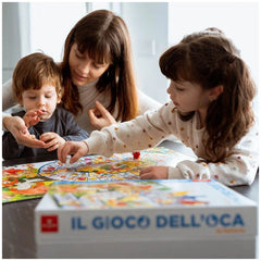 Dal Negro - The Goose Game - The Farm Board Games Set on a reflective table with a woman and two children in matching white s