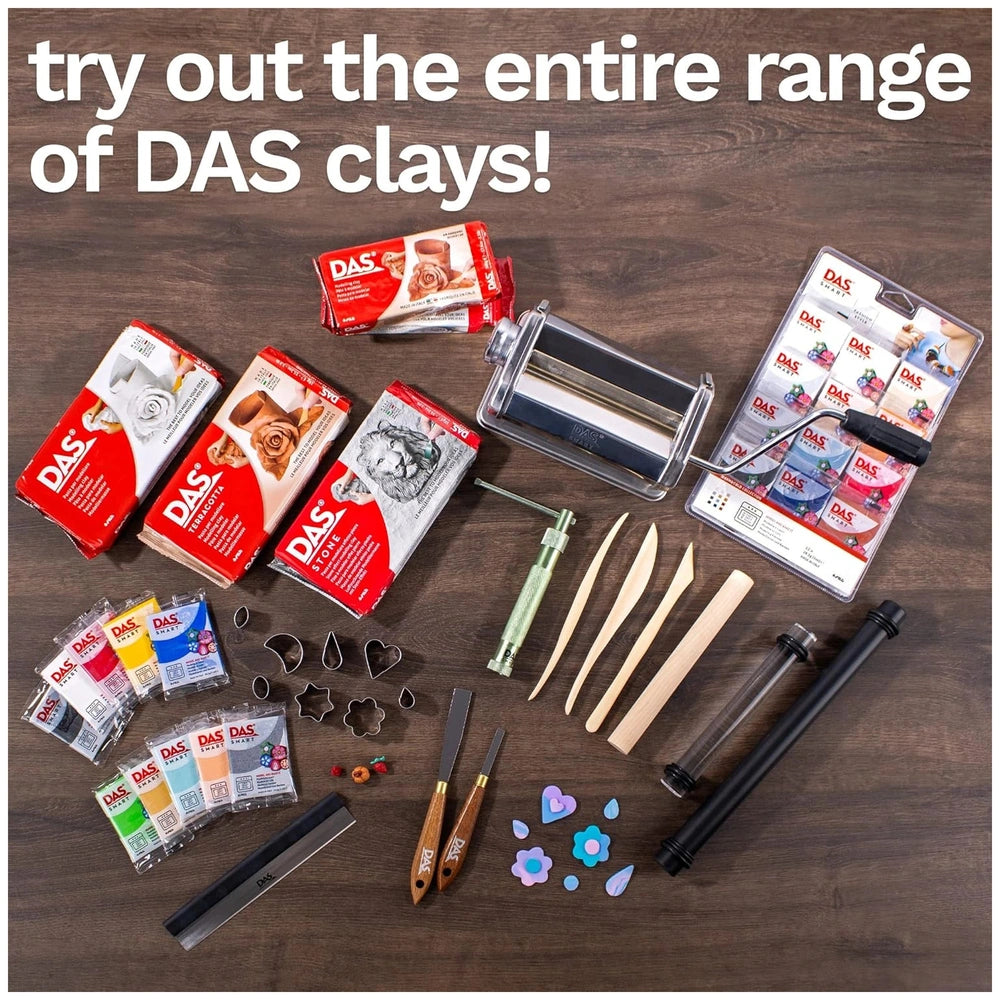 DAS Modeling Clay in red and white packaging displayed on a brown table with various clay tools and accessories.