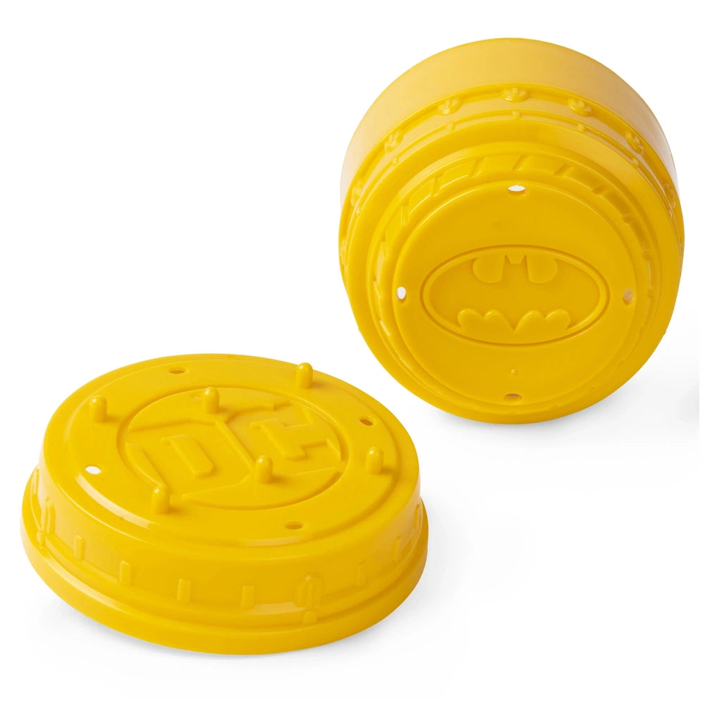 DC Comics BATMAN Collectible Blind Box Mini Figure features two bright yellow circular objects with a textured surface.