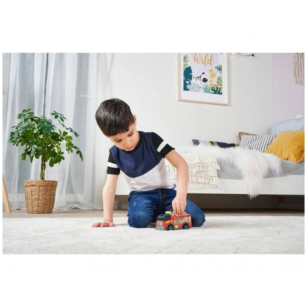 Dickie fire truck play vehicle with lights and sounds, featured in a cozy living room with a child and stylish decor.