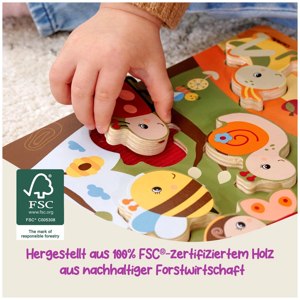 Eichhorn Bee-Happy Sensory Puzzle features colorful wooden animal shapes, with a childs hand holding a piece on a carpeted f