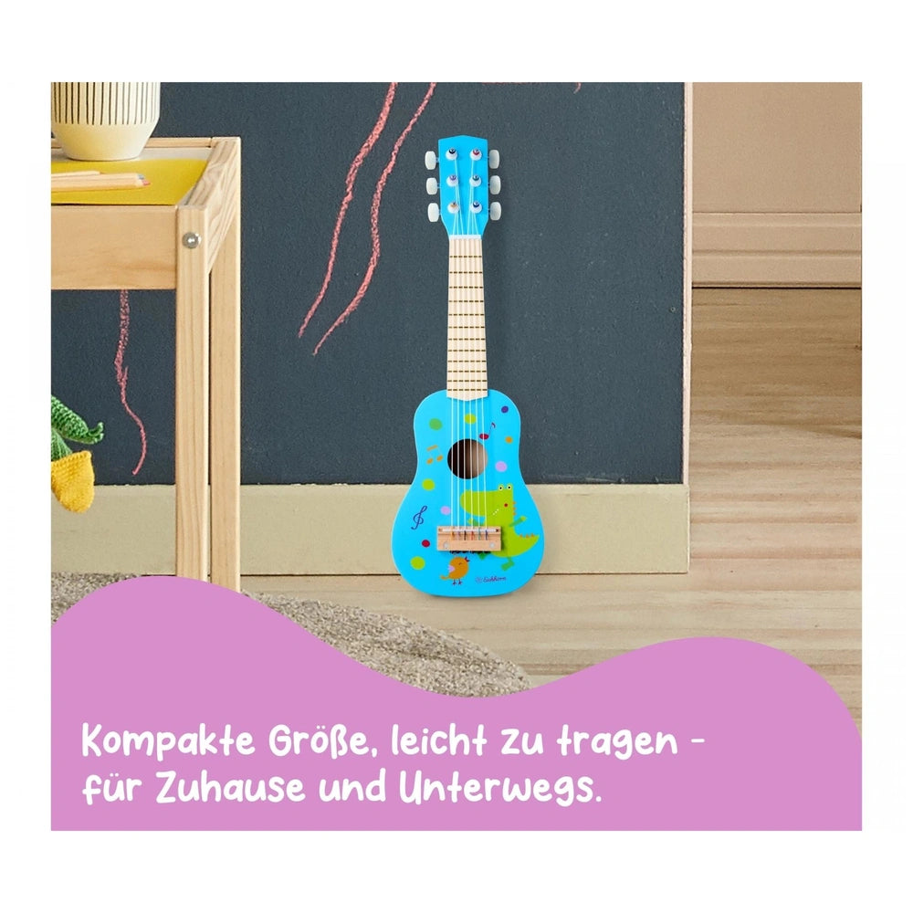 Eichhorn Music Wooden Guitar 54cm in blue with playful designs, set in a colorful childs room.
