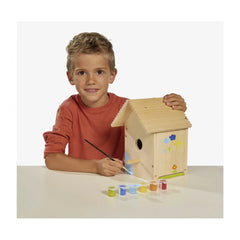 Eichhorn Outdoor Make your own Birdhouse kit, featuring a smiling boy painting a wooden birdhouse at a white table.
