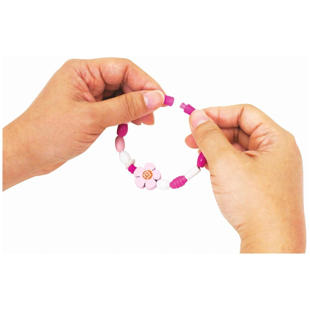 Eichhorn Wooden Bead Set features a colorful bracelet held between two hands against a plain white background.